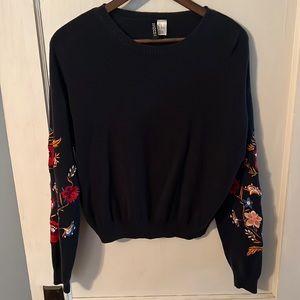 Navy sweater with floral sleeve